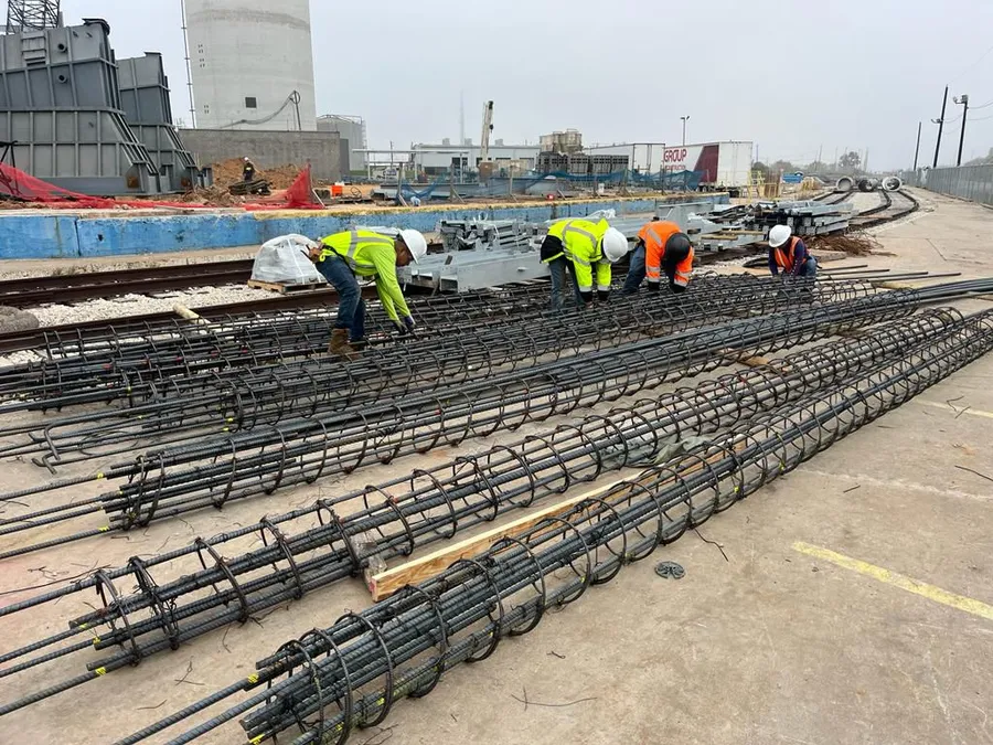 Workers assembling reinforcing steel for concrete construction.